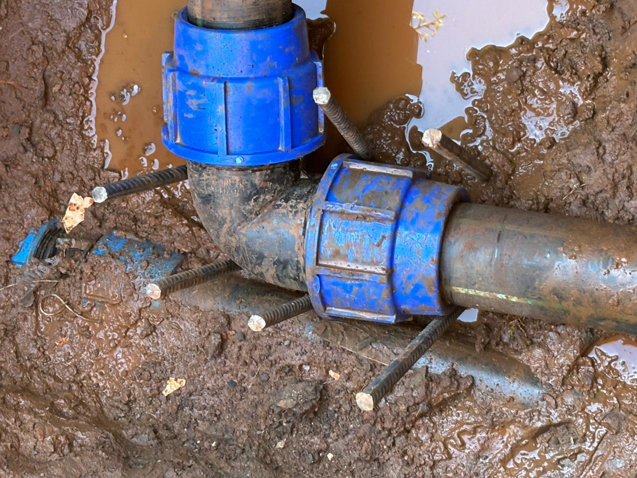 Underground water pipe repaired with compression couplings